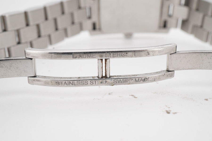 A lady's late 1990's stainless steel Baume & Mercier quartz wrist watch, with white rectangular dial and subsidiary seconds, case diameter 20mm, with guarantee card and booklet.